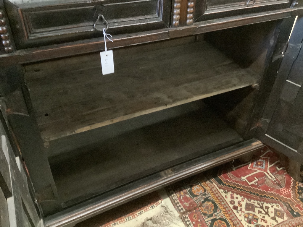 An early 18th century and later oak cupboard, with two frieze drawers, width 115cm